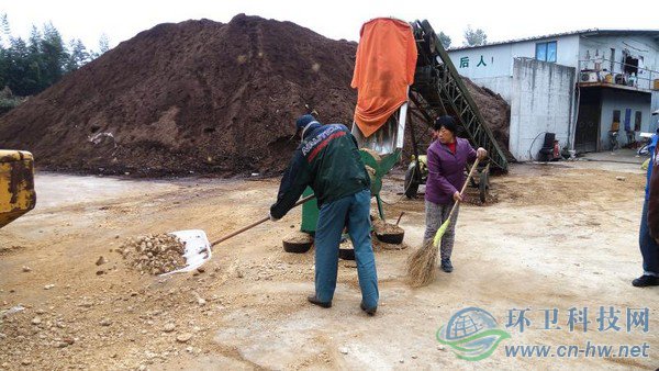 工人將機器碾碎的園林廢棄物鏟入發(fā)酵堆，噴灑生物菌劑攪拌后，自然發(fā)酵兩到四個月，就能成為有機介質(zhì)，用來改良土壤